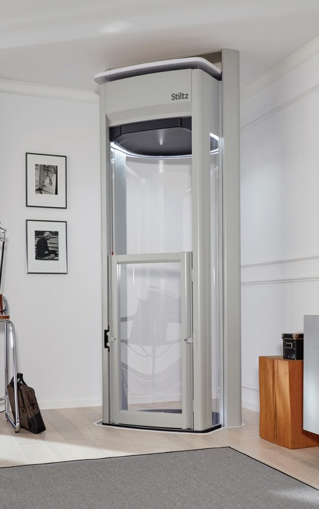 Glass-fronted home lift in a living space