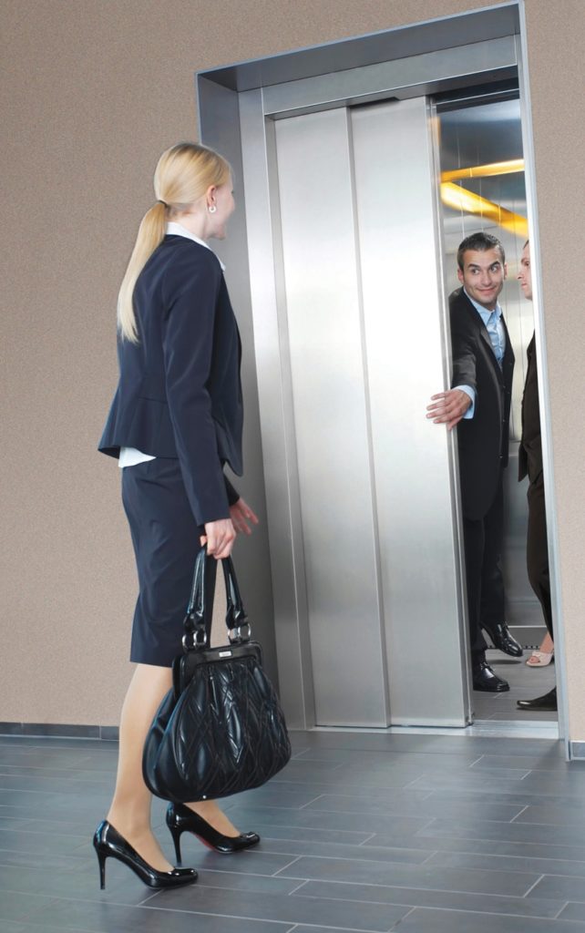Passenger stepping out of a steel passenger lift